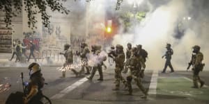 Militarised federal agents deployed by the President to Portland,Oregon,fire tear gas at protesters.