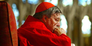 Cardinal George Pell in contemplation during a Sydney mass in 2004.