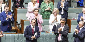 Treasurer Dr Jim Chalmers is congratulated by colleagues after delivering the Budget speech.