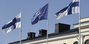 Finnish and NATO flags flutter at the courtyard of the Foreign Ministry in Helsinki,Finland.