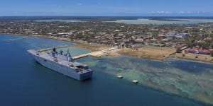 In this photo provided by the Australian Defence Force,HMAS Adelaide provides disaster aid while docked at Nuku’alofa,Tonga,on January 27. Tonga is now in lockdown after dock workers contracted COVID.