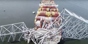An image taken from video released by the National Transportation and Safety Board,the cargo ship Dali is stuck under part of the structure of the Francis Scott Key Bridge.