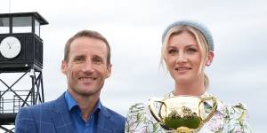 Damien Oliver and Jamie Kah pose with the Melbourne Cup.