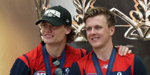 James Jordon (right) and his Melbourne teammate Trent Rivers with their premiership medallions.