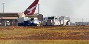 Buses wait to transport passengers from a flight to the Howard Springs quarantine facility.