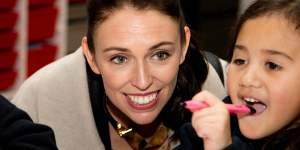 New Zealand Labour Party leader Jacinda Ardern sits with a student in their classroom during a visit to Addington School in Christchurch.