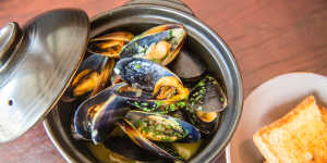 Mussels in white wine demand hot-buttered bread and a glass of something cold.