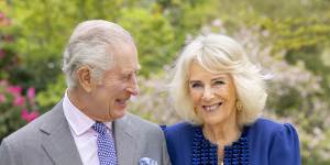 Britain’s King Charles III and Queen Camilla stand in Buckingham Palace Gardens the day after their 19th wedding anniversary. 