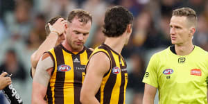 Tom Mitchell speaks with field umpire Hayden Gavine after a 50-metre penalty was awarded.