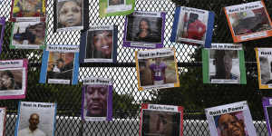 Photos of black victims are displayed on a fence at Black Lives Matter Plaza,Washington. 