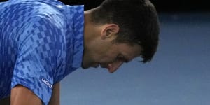 Novak Djokovic of Serbia falls to the court during his third round match against Grigor Dimitrov of Bulgaria.
