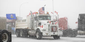 Anti-COVID-19 vaccine mandate demonstrators gather as a truck convoy blocks the highway at the busy U.S. border crossing in Coutts,Alberta,Canada.