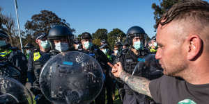 A protester confronts police.