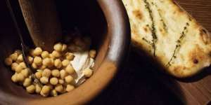 Warm hummus with freshly baked taboon Palestinian bread.