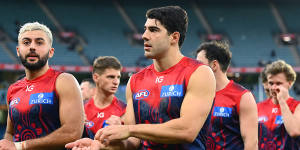 Christian Salem and Christian Petracca and their Demons teammates look dejected after losing in round 11.