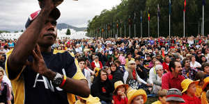 Thousands of people watch TV screens on the Parliament lawns as Australian Prime Minister Kevin Rudd delivers an apology to the Aboriginal people for injustices committed over two centuries of white settlement,February 13,2008.