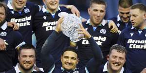 Scotland’s Sione Tuipulotu raises the Hopetoun Cup trophy.