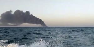Smoke rises from Iran’s navy support ship Kharg before it sank in the Gulf of Oman.