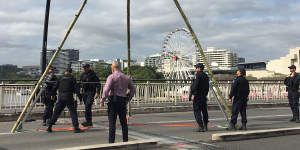 The protest on Monday involved a structure on Victoria Bridge from which a woman dangled.