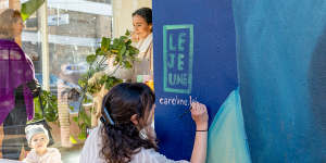 Caroline Lejeune adding the finishing touches to her mural in Collingwood.