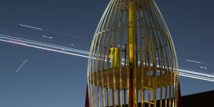 Rocket play equipment in Enmore Park with time-lapse lights from landing aircraft. 