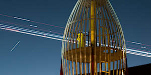 Rocket play equipment in Enmore Park with time-lapse lights from landing aircraft. 