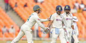 Virat Kohli is congratulated by Alex Carey after his 186.