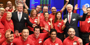 Coles managing director Steven Cain (in suit,left) and chairman James Graham (right) with Coles staff at its ASX listing ceremony on Wednesday. 