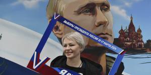 A woman poses with a frame with the words “I have chosen the president” after voting at a polling station in Donetsk,the Russian-controlled region of eastern Ukraine.