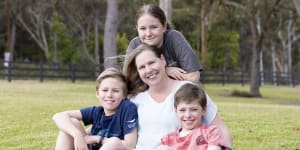 Bronwyn Grout is an ovarian cancer ‘Super Survivor’ 15yrs after her diagnosis. pictures show her at her Wyee Point home with her children Emily,13yrs,and twin boys Thomas (Red tshirt) and Daniel (Dark Blue tshirt) age 11yrs. 2nd Dec 2022 . pic by Peter Stoop/SMH .