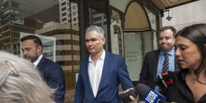 Former federal Labor MP Craig Thomson (centre) leaves Downing Centre Local Court after pleading guilty to fraud offences.