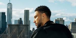 Simmons on the balcony of his new eight-bedroom apartment in Brooklyn. 