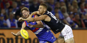 Former Blue Liam Jones spoils Mitch Hannan of the Bulldogs.