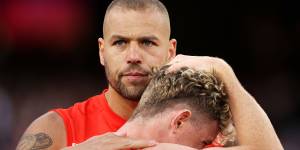 Lance Franklin consoles Chad Warner,the man who set up his famous 1000th goal,after Sydney’s grand final debacle.