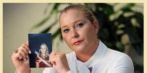 Virginia Giuffre in 2022,with a photo of herself as a teenager.