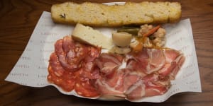 A snacky selection of salumi and cheese with giardiniera pickles.