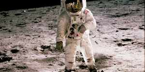 Buzz Aldrin walks on the moon during the first human landing in 1969. Fellow astronaut,Neil Armstrong,the first to set foot on the moon,is seen reflected in Aldrin’s helmet glass.