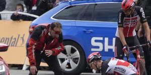 Teammates tend to Ewan after he crashed in the sprint towards the finish line. 