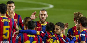 Lionel Messi is congratulated by Barcelona teammates after scoring against Getafe on Thursday (Friday AEST).