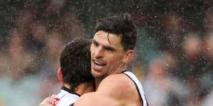 Nick Daicos celebrates a goal,much to Scott Pendlebury’s approval.