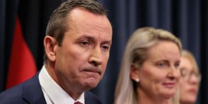 Mark McGowan was flanked by his wife,Sarah,and most of the state’s cabinet at his press conference on Monday.