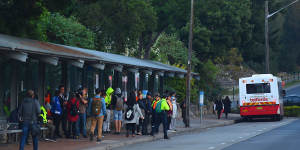 Commuters wait for a bus at Strathfield train station during the bus strike.