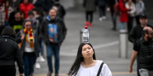 Kelly Huynh finds joy walking with a bottle of water on her head,soaking up smiles as she walks the streets of Melbourne.
