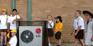 Sweltering schools forced to wait for network upgrades before they turn on aircon