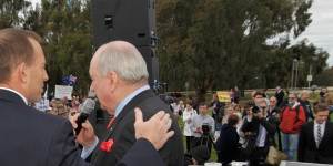 Then opposition leader Tony Abbott is embraced by broadcaster Alan Jones after he addressed the'no-confidence'rally outside Parliament House in Canberra.
