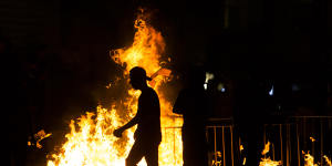 Palestinians stand next to a burning barricade during clashes with Israeli police officers on May 8. 