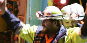 Miners Todd Russell,left,and Brant Webb,smile as the arrive above ground after spending two weeks trapped nearly a kilometre (3,000 feet) underground in the Beaconsfield Gold Mine at Beaconsfield,Australia,Tuesday,May 9,2006. After initial medical tests underground,Webb,37,and Russell,34,strode purposefully from the mine's main lift shaft and hugged family and friends before clambering into two ambulances,still laughing and joking with friends. (AP Photo/Ian Waldie,Pool)
