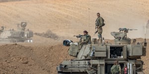 Israeli soldiers prepare their vehicles in the city of Netivot amid retaliations in the Gaza Strip.