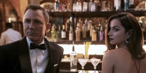 Daniel Craig,left,with Ana de Armas in the Alexandra dress by Sydney designer Michael Lo Sordo.