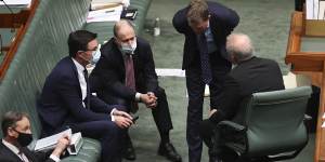 Prime Minister Scott Morrison and members of his cabinet consult during question time.
